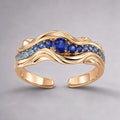 The Nereid Cuff in high-polish 18K warm gold vermeil sterling silver, a sculptural wave cuff set with gradient blue sapphires and a royal-blue centre stone, front view