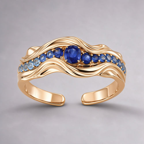 The Nereid Cuff in high-polish 18K warm gold vermeil sterling silver, a sculptural wave cuff set with gradient blue sapphires and a royal-blue centre stone, front view
