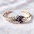 The Plume Cuff — 18K Gold Vermeil Feather Bangle with Royal Blue Lab Sapphire
