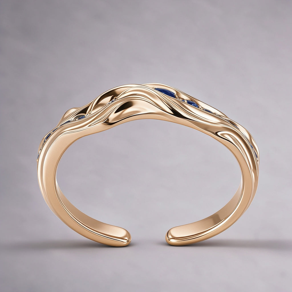 The Nereid Cuff from the side, showing the full open C form, folded gold waves and inward-curving rounded terminals