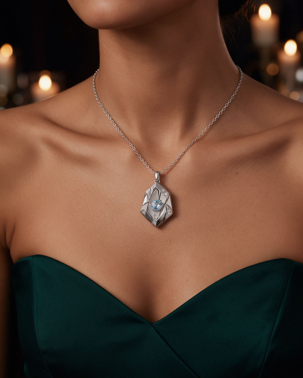 The Glacier Pendant worn with an emerald strapless gown by candlelight, the faceted white gold pendant resting at the
